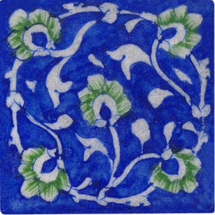 white and green floral design on blue tile 3x3