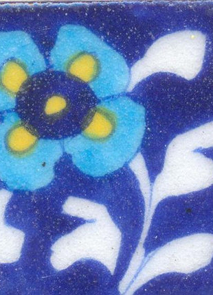 Turquoise and Yellow flower With White Leaves On Blue Base Tile
