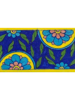 blue tile with turquoise and pink flowers and green leaves