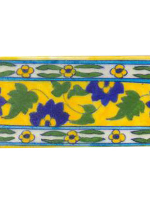 Blue flower and green leaves with yellow tile