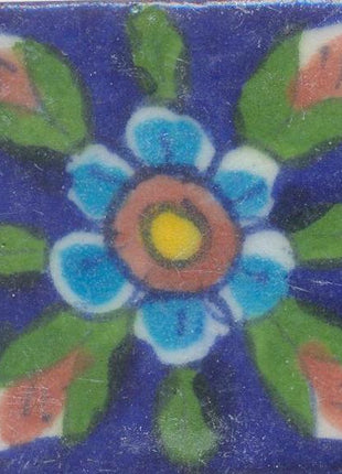 Turquoise Flowers With Brown and Yellow Center and green Leaves On Blue Tile