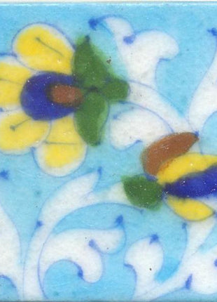 Yellow and Blue Flowers With White Leaves On Turquoise Base Tile