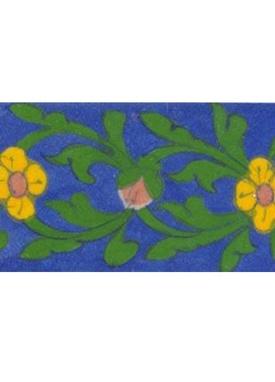 yellow flower with green leaves on blue tile
