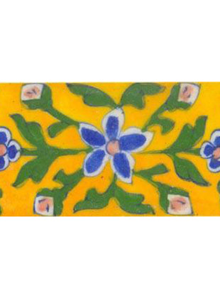 yellow tile painted with blue, pink green design 2x4