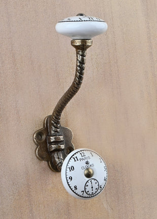 Black Clock on a White Ceramic Knob With Metal Wall Hanger