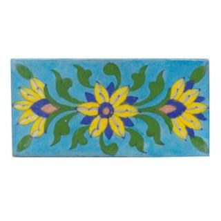 Three yellow,blue,brown and green leaves with turqouise tile