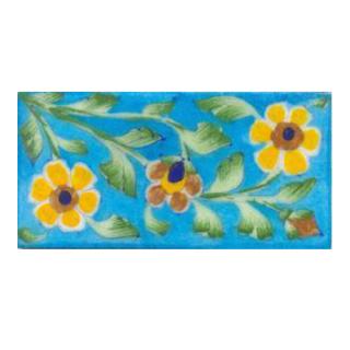 Two yellow and one brown flower and turqouise tile