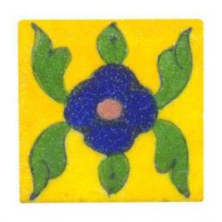 Green leaves with blue flower on yellow tile